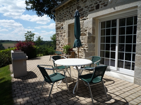 Terrasse avec salon de jardin et barbecue - Location de vacances - Scrignac